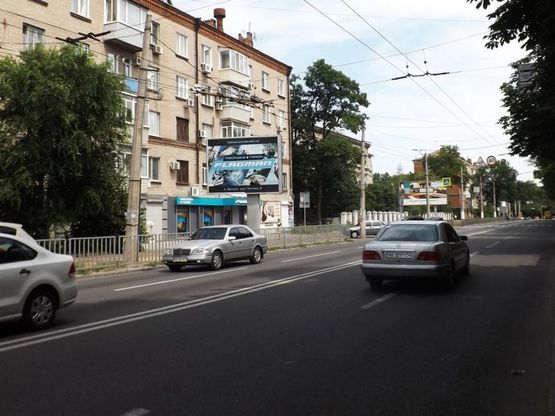Фото рекламной плоскости по адресу вул.Тітова, 6/ул.Титова, 6, большой поток движения, плоскость расположена между ТЦ Апполо и ТЦ Дафи Фото рекламной плоскости по адресу вул.Тітова, 6/ул.Титова, 6, большой поток движения, плоскость расположена между ТЦ Апполо и ТЦ Дафи
