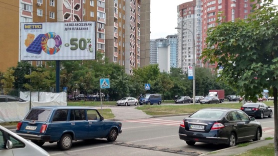 Фото рекламной плоскости по адресу Ул. Ахматовой, 44, на РАЗДЕЛИТЕЛЕ, светофор. НОВУС, АТБ, Велика кишеня, ресторан "Чайхона базар", ТЦ "ЕкоТайм", River Mall.  В сторону Днепровской набережной