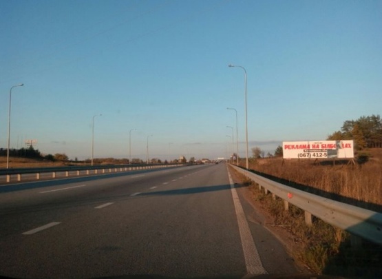 Фото рекламної площини за адресою Траса Житомир-Київ.Об'їздна Коростишева. Напроти комплексу"Вояж", напрямок з Житомира на Київ, 3х12 ст.А